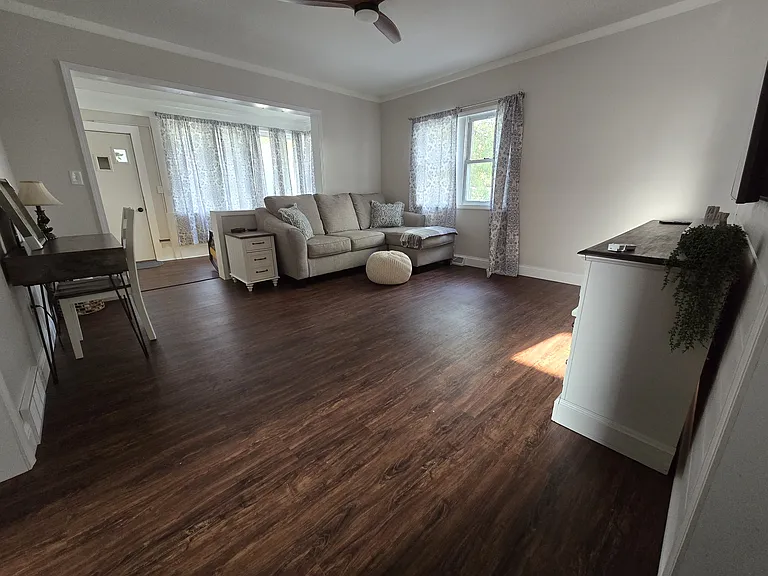 Living room with ceiling fan, 65" Samsung TV, Samsung sound bar w/subwoofer, desk Also, end table w/USB.