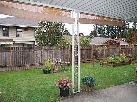 Covered patio looks out on beautiful yard