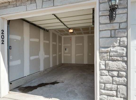 Detached single-car garage included with unit.
