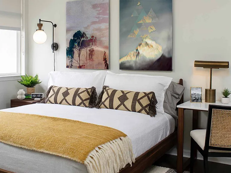 Spacious apartment bedroom with wood floors.