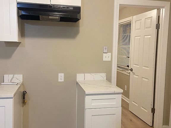 Newly updated kitchen featuring elegant granite countertops, abundant cabinet space for all your storage needs, washer/dryer hookups, and a gas stove hookup, perfect for home chefs.