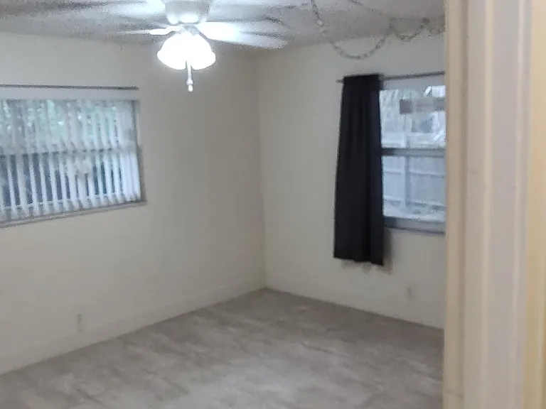 Master bedroom-- lots of sunlight, windows to huge private yard