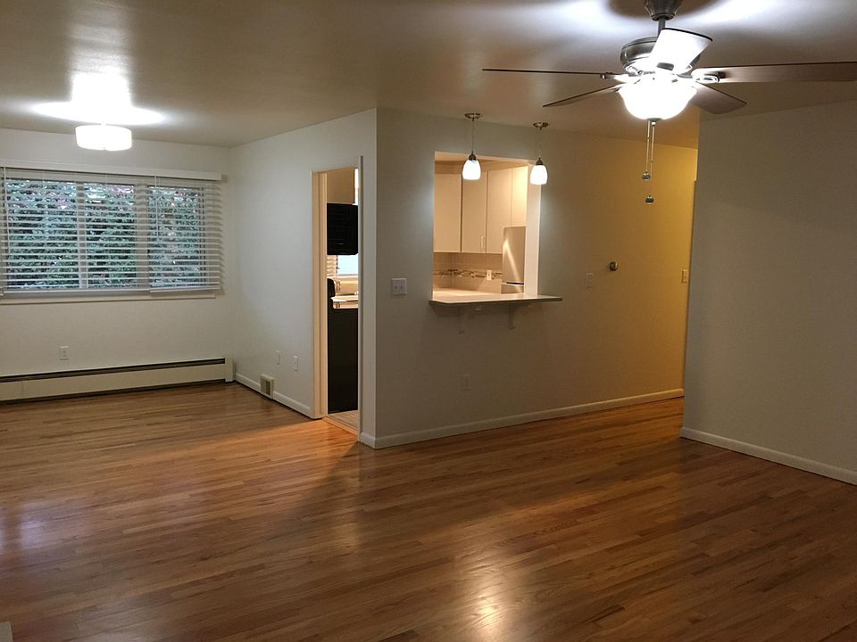 Living room view to dining and renovated kitchen and granite counter breakfast bar