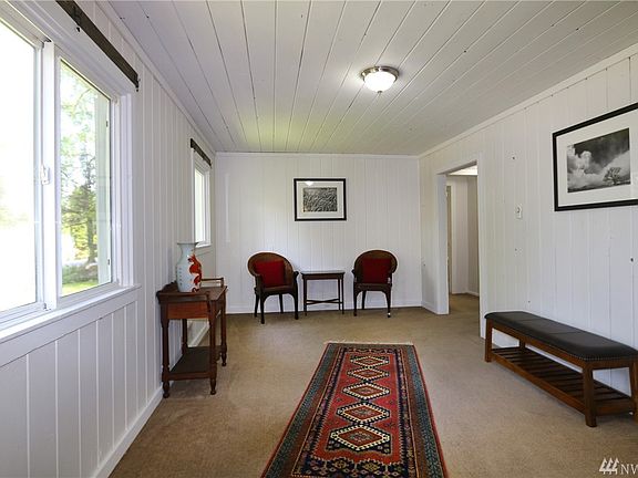 Head into the bedrooms or kitchen through the doorway to the right.