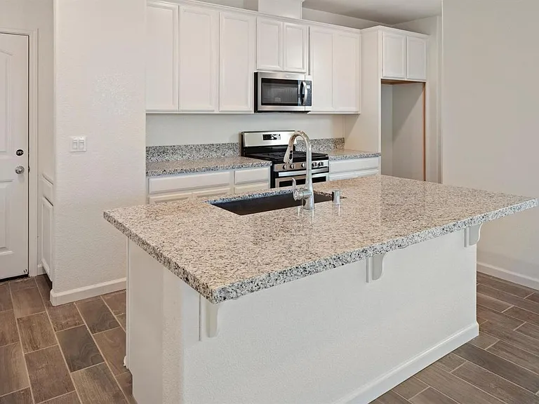 Granite countertop (Refrigerator in the top-right not yet installed when this picture was taken)