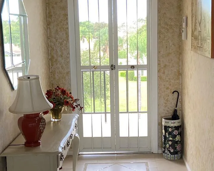 Front entrance door opens out onto the exterior walkway. An interior folding locking screen door provides natural air flow through the condo.