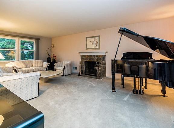 Spacious living rm w/ wood-burning stone fireplace