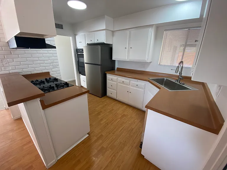 Updated kitchen with new appliances and lighting.