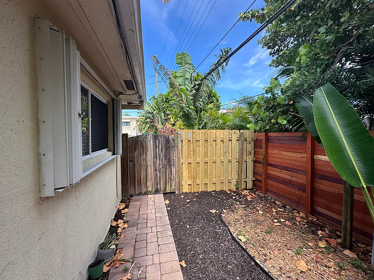 Your Semi Private Backyard area for lounge chairs, table, BBQ etc. (with rear door not showing on left). Parking lot on other side of new fencing