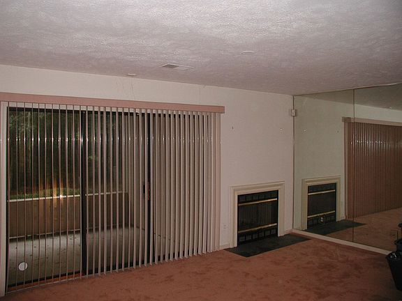 Den with second fireplace