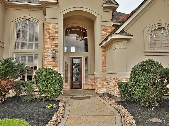 WELCOME TO 8902 STERLING GATE ESTATES - Guests are welcomed through this architectural artistry with stacked stone complimenting the stucco exterior. A stamped concrete walkway & driveway is a beautiful added feature. The home is impeccably manicured