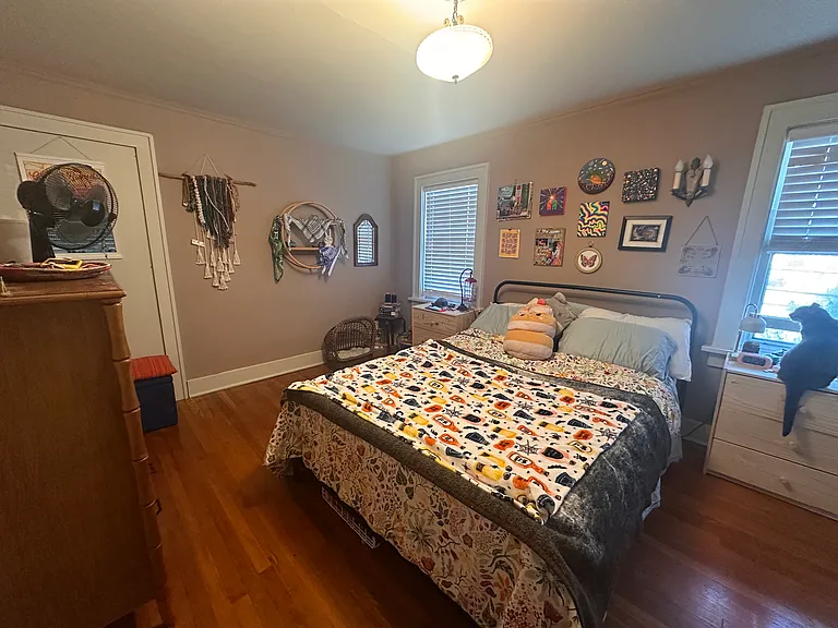 Primary bedroom boasts natural light and fits a king size bed and has a walk-in closet