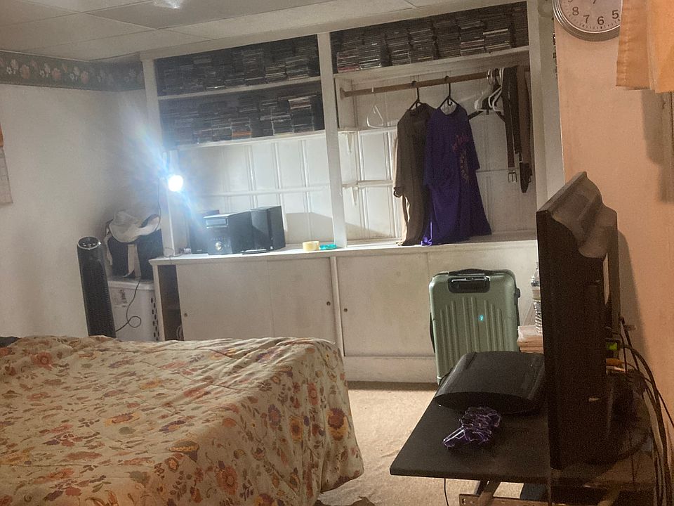 Bedroom clothing unit TV _ full sized bed can be turned up against the wall for more walk. Space.