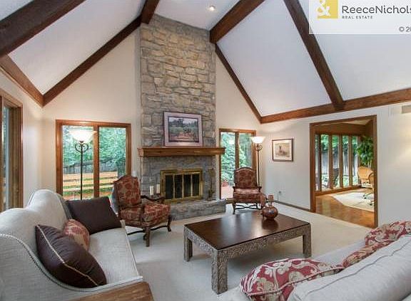 Home is flooded with natural light from all of the large windows.   Real masonry on floor to ceiling fireplace.