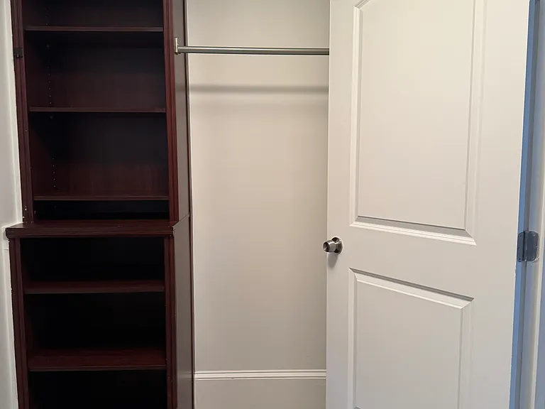 Upstairs primary closet, 2 cabinets + 2 clothing rods.