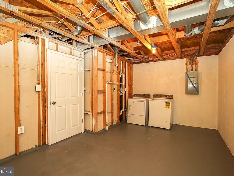 Laundry room and unfinished storage. New washer and dryer not shown.
