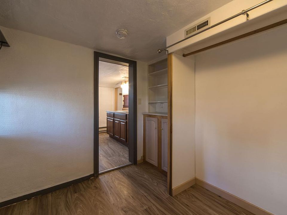 Bedroom closet with view to kitchen
