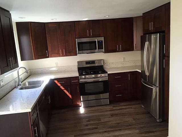 Sunny kitchen has window & sliding glass door