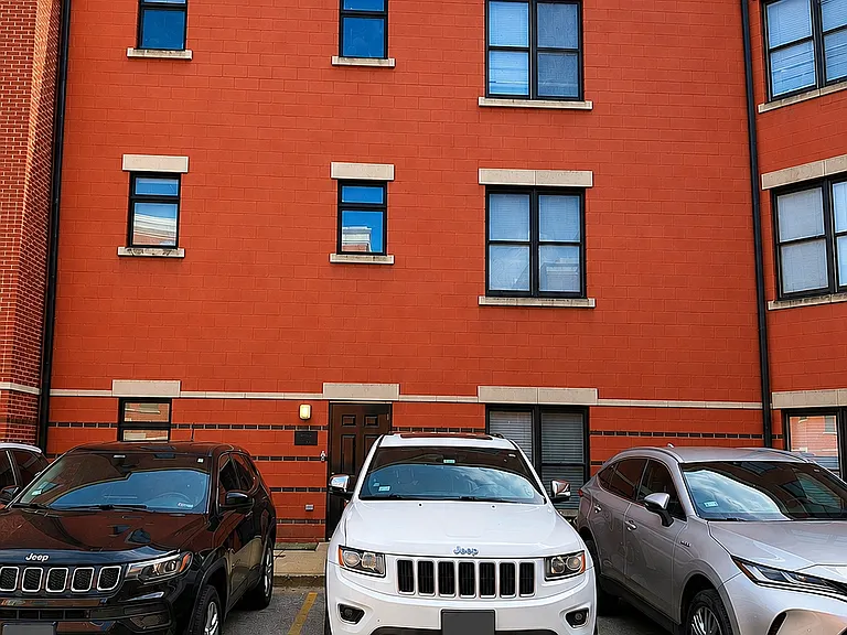 Rear Elevation With Private Parking Pad. The white Jeep is parking in #68