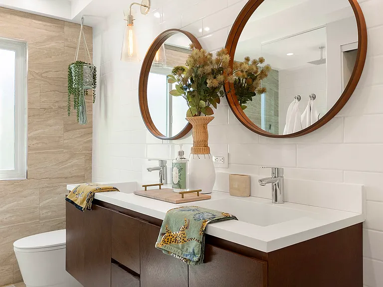 Primary en-suite spa bathroom with rain shower and double vanity.