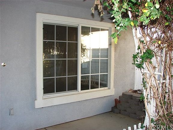 FRONT PATIO/PORCH AND SHADED LIVING ROOM WINDOW.