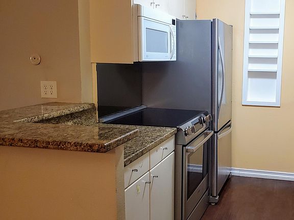 Large fridge. Flat top range with convection oven. Pull out drawers in cabinets.