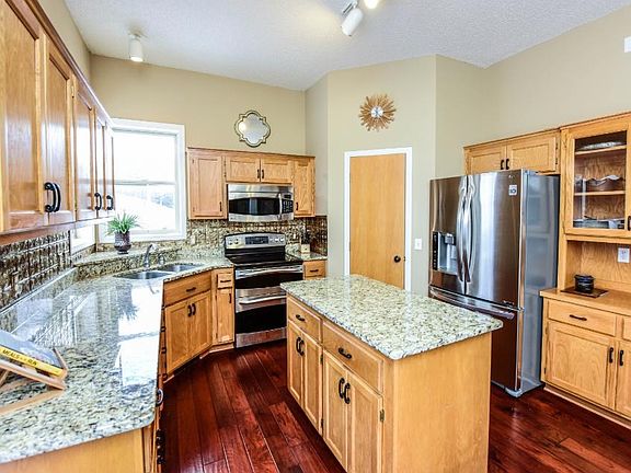 Granite countertops, stainless steel appliances, kitchen window