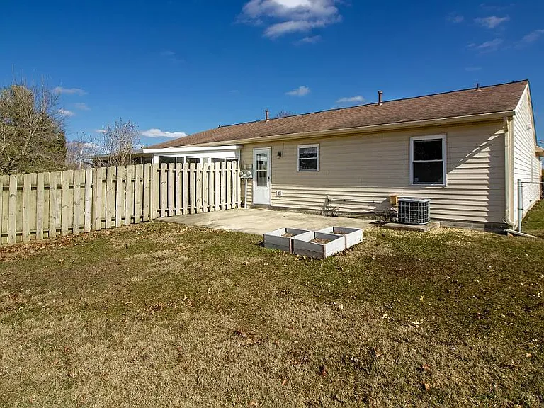 large fenced in back yard, with shed