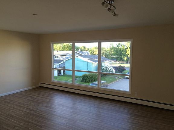 Living room is spacious with large windows and views of the mountains