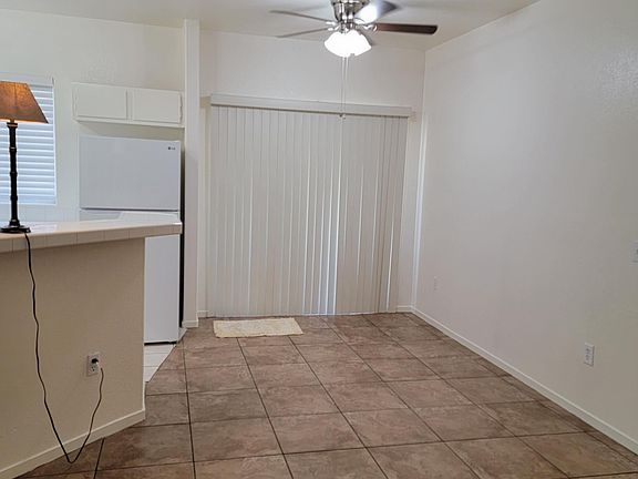 Kitchen dining area, freshly painted, ceiling fan, new blinds on patio door leading to patio, and bar height counter top.