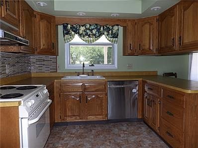 Enjoy this updated kitchen with new dishwasher & refrigerator & newer range. New back splash & paint completes this kitchen.