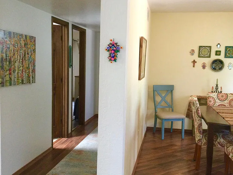On the right is the dining room and kitchen, and on the left, the hallway to the bedrooms and bath. The living room is a hard left before the stairs going down to the bonus room.