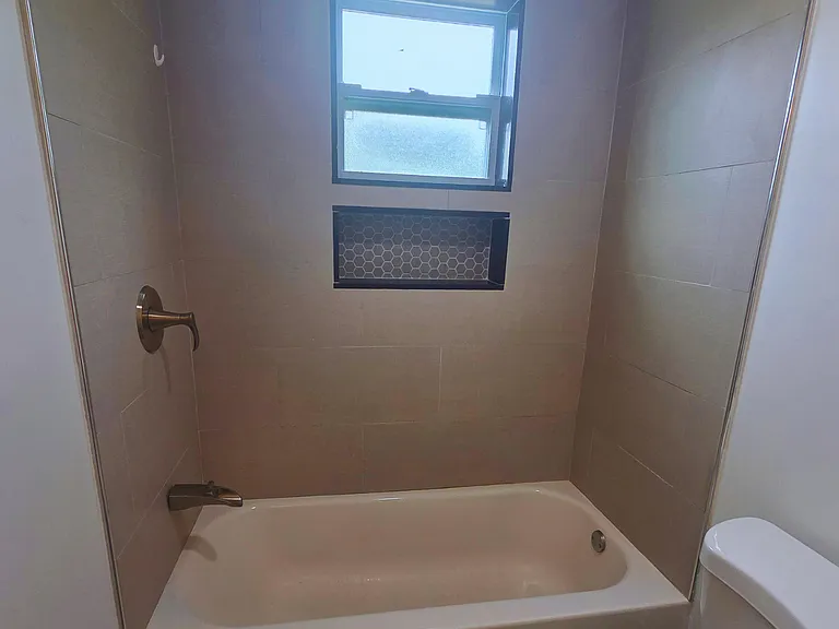 Immaculate bathroom with tub and toilet for your comfort