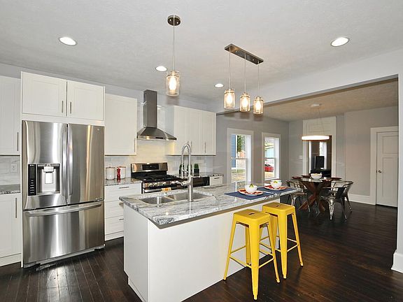 Sleek, modern kitchen with granite countertops and gas range