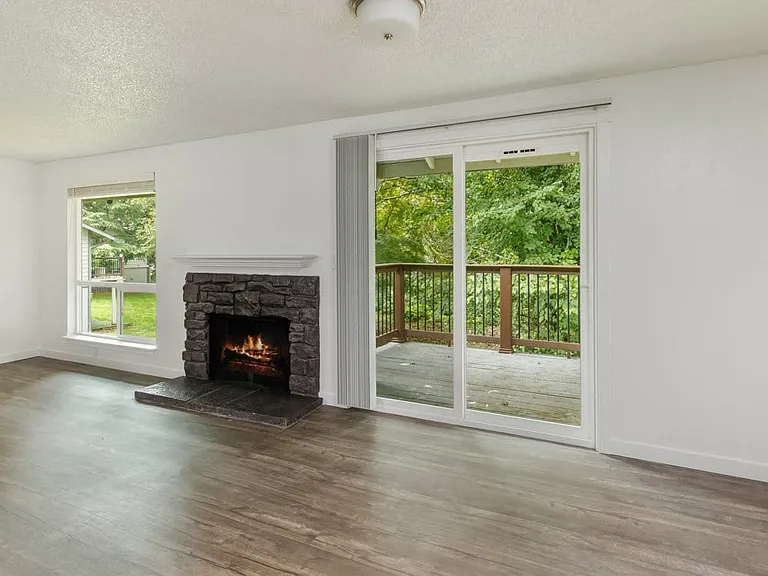 Our Apartment Fireplace with Balcony at Wilderness West Apartments in Olympia, Washington