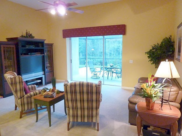 Large family room leads through pocket sliders to oversized screened lanai.
