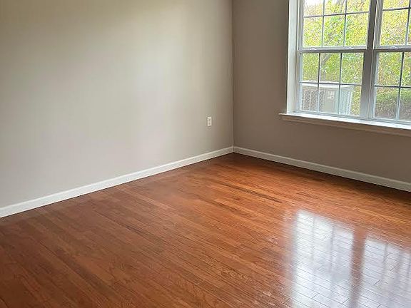 Spacious master bedroom with continued hardwoods