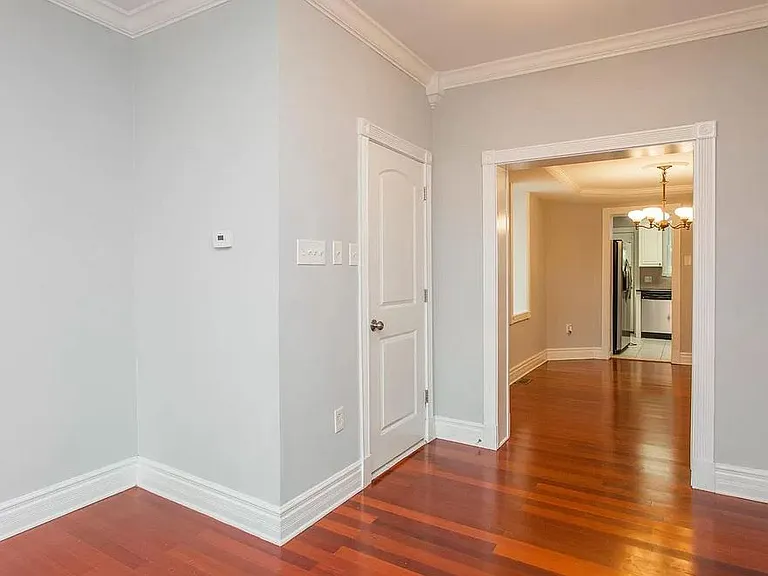 Unfurnished Powder Room Door with Dining Room behind it. View from Living Room