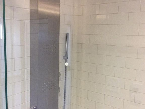 Rainfall shower with massaging jets