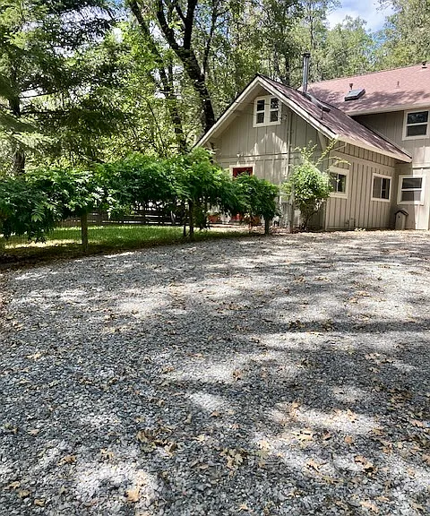 House and fenced front lawn.
