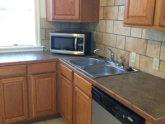 Open kitchen with dishwasher, refrigerator, oven/stove, micr