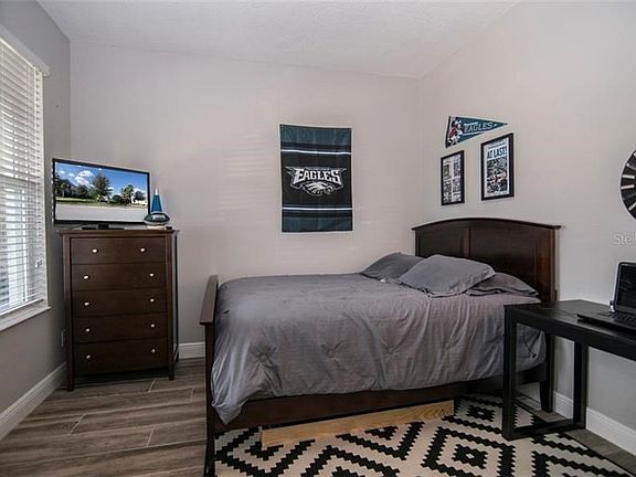 Study, used as bedroom, overlooking front porch and green space.