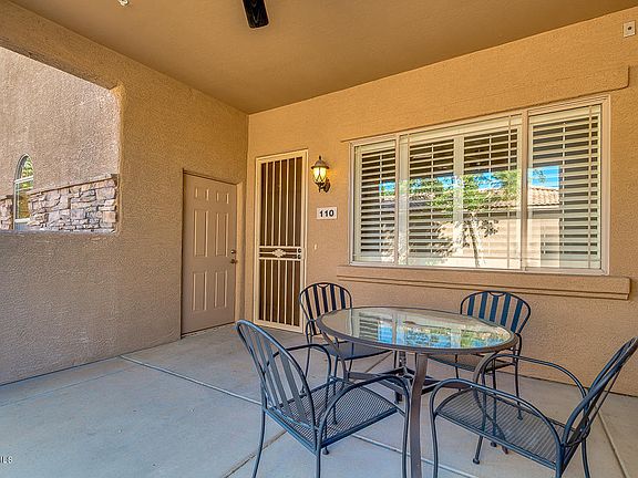 Large front patio with ceiling fan and small closet