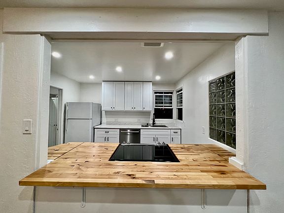 Kitchen with butcher block counter top and seating for 2-3 people