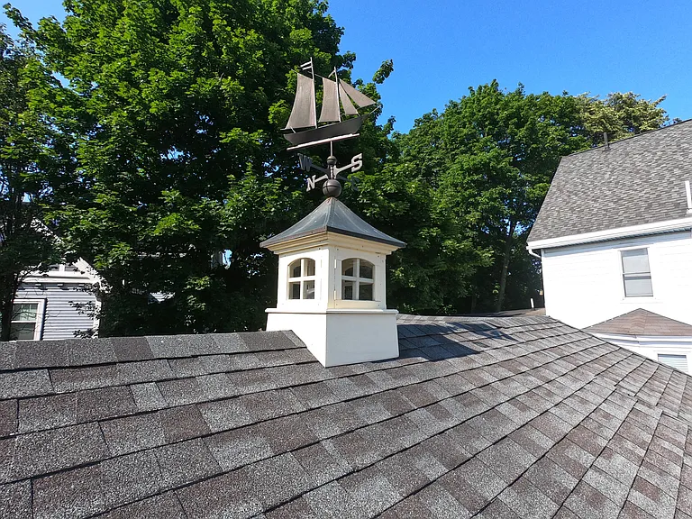 Decorative weathervane on roof.