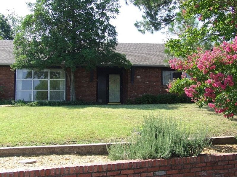 Full brick home perched hilltop.