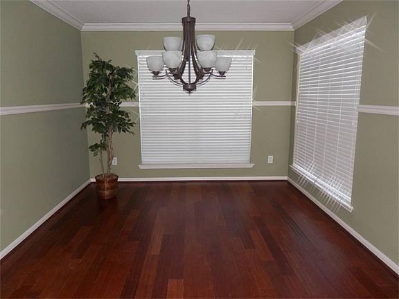 Formal dining room with a view of the outdoors, or, with blinds closed, private dining for those intimate moments together.