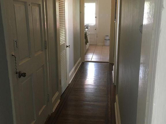 Hallway tp bedroom, bathroom and kitchen with front entry and large closet on the left.