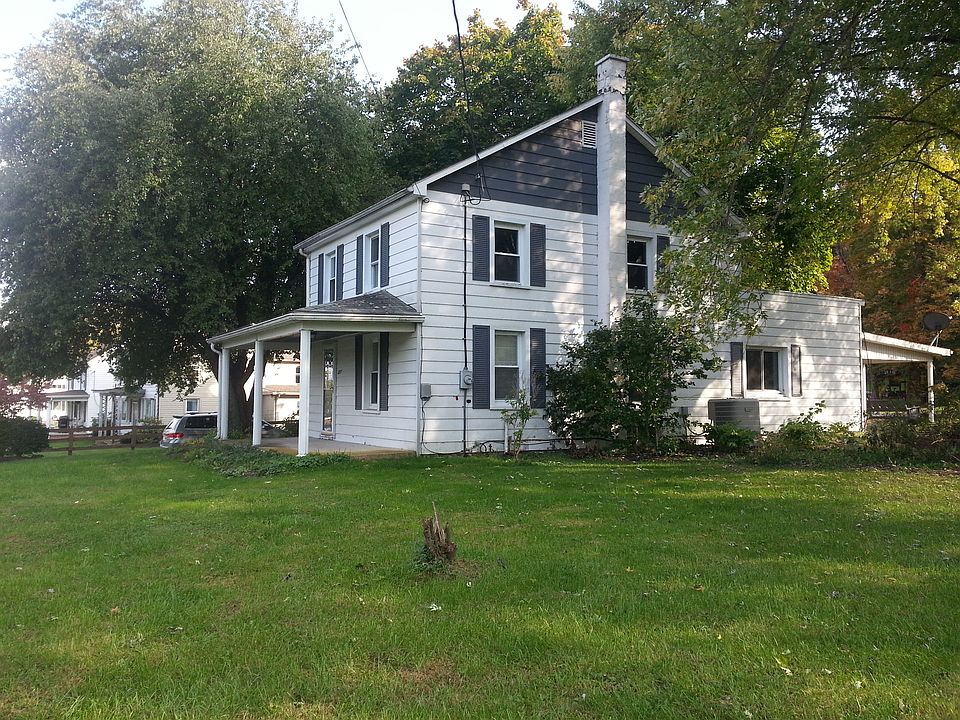 mature trees surround house