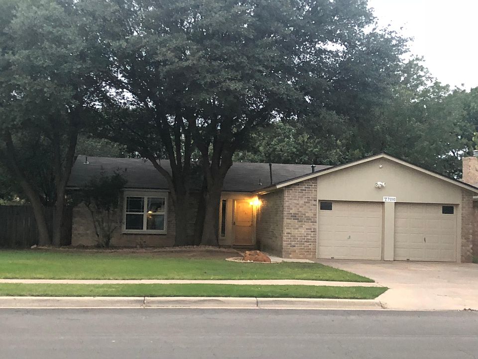 Nicely maintained lawn with large, mature shade trees